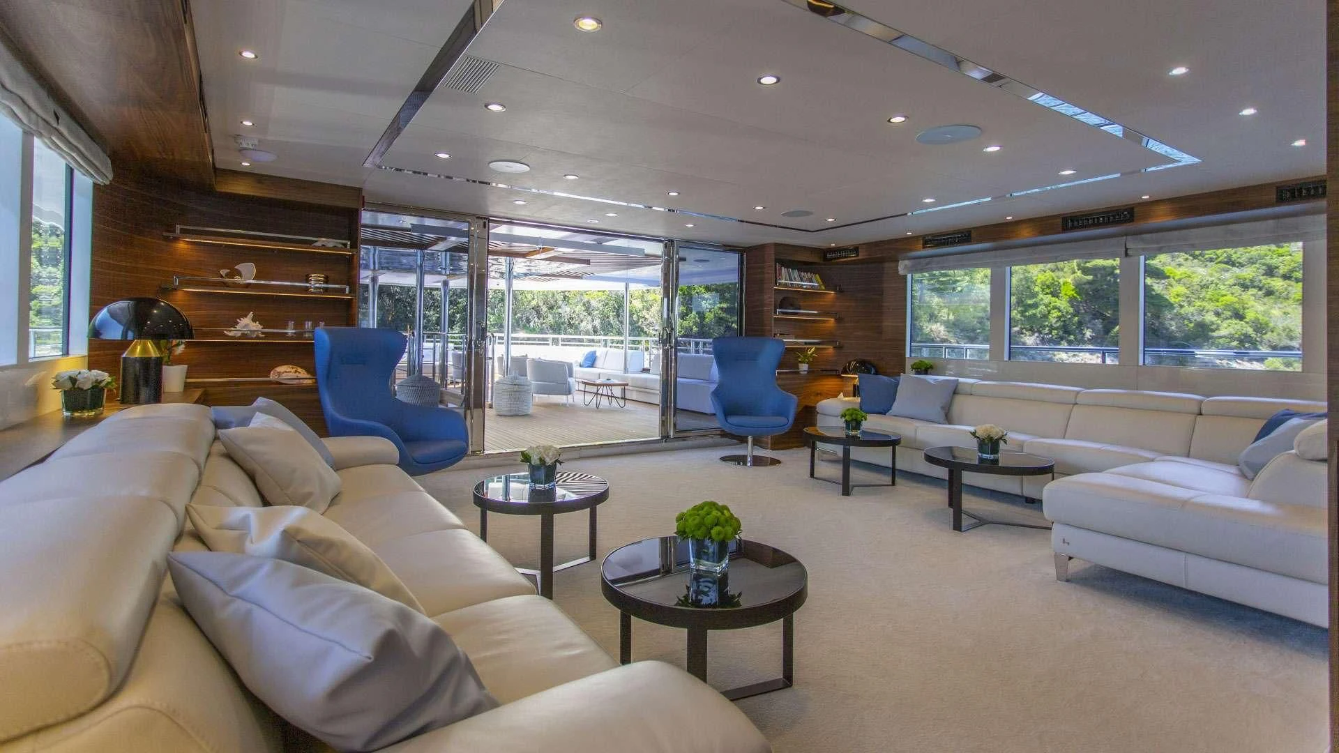 a living room with a large window aboard M/Y ANTHEA Yacht for Sale
