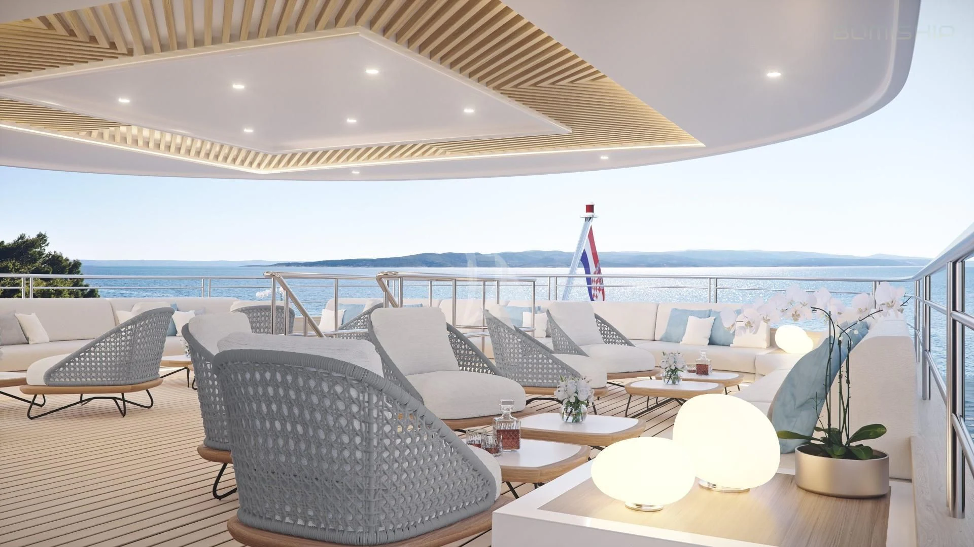 a large lounge area with a large white lounge chair and a large body of water aboard M/Y ANTHEA Yacht for Sale