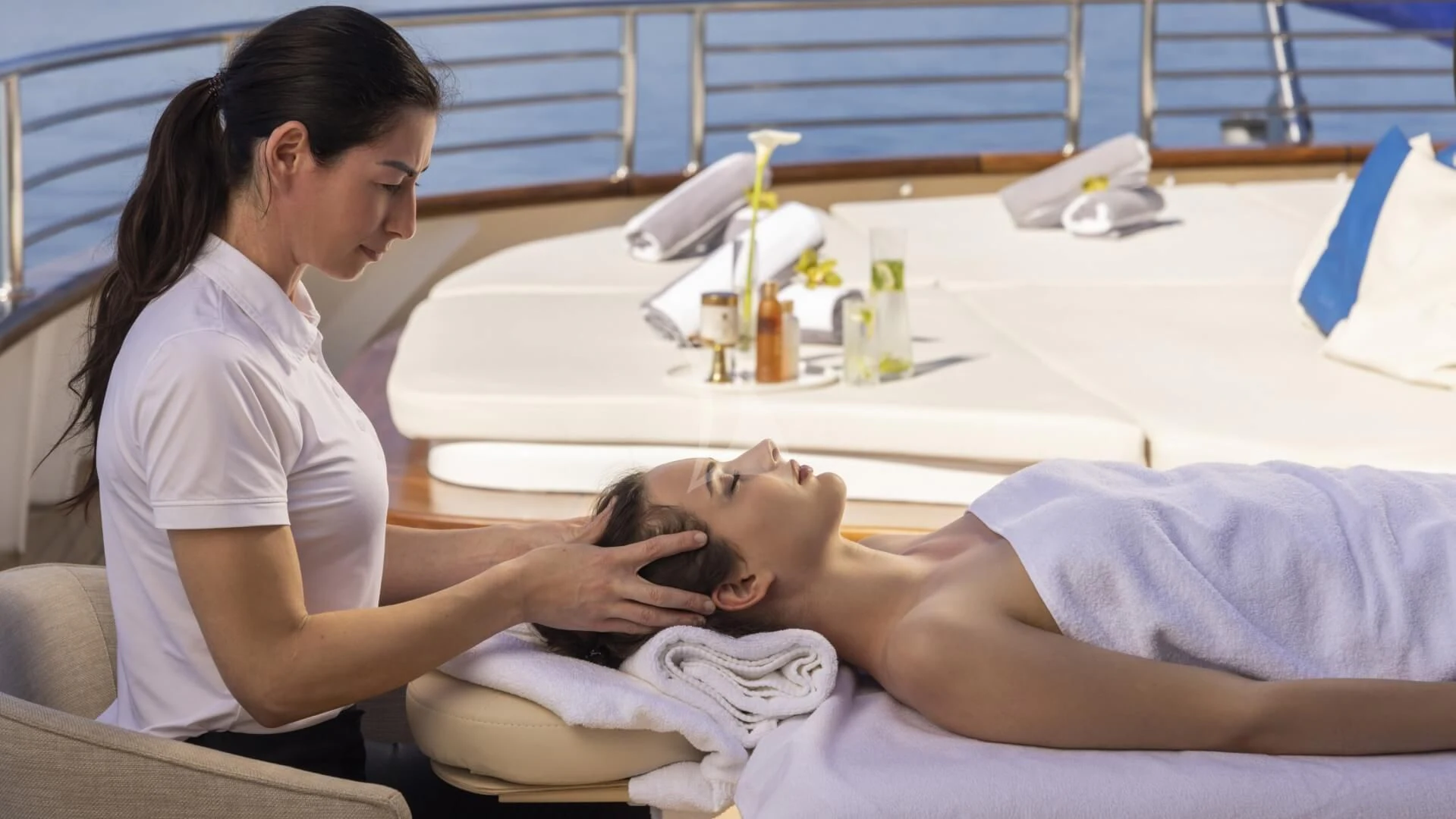 a woman holding a baby aboard M/Y ANTHEA Yacht for Sale