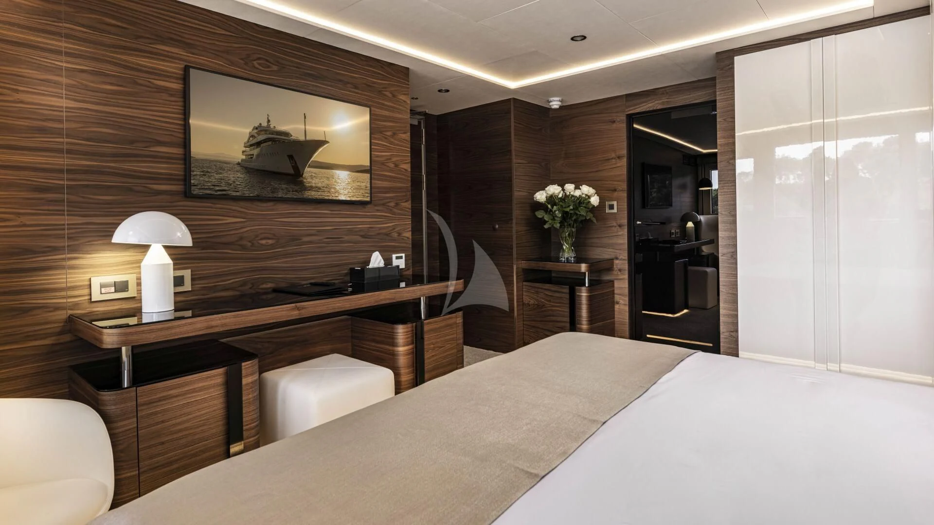 a hotel room with a bed and a desk aboard M/Y ANTHEA Yacht for Sale