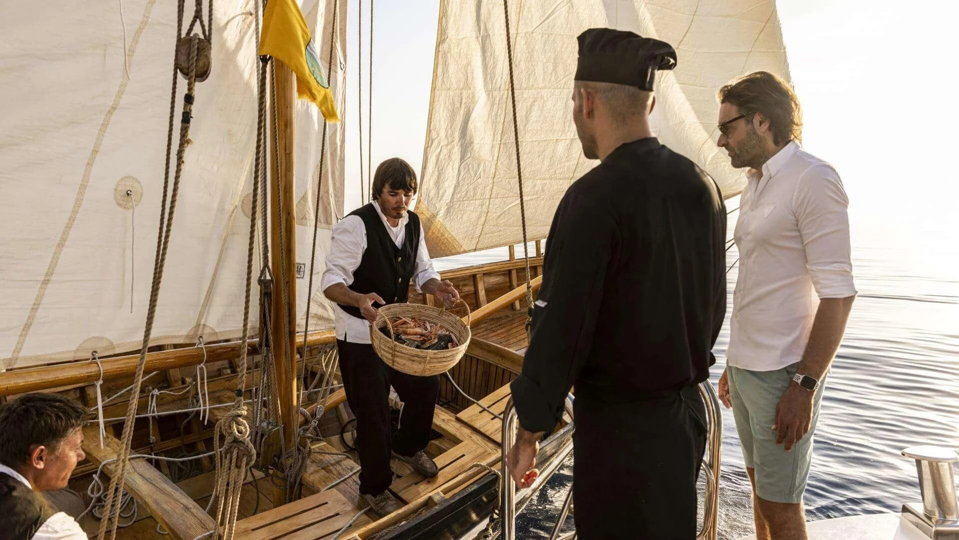 a group of people standing around a boat aboard M/Y ANTHEA Yacht for Sale