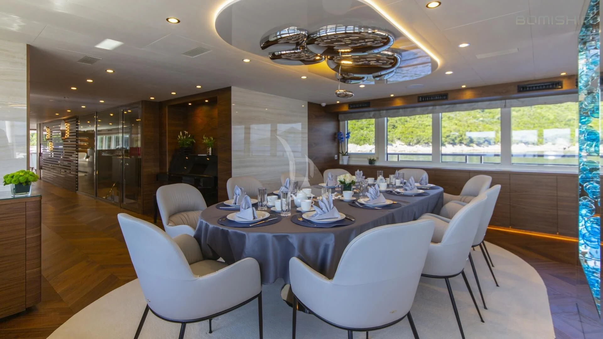 a large dining room with a large table and chairs aboard M/Y ANTHEA Yacht for Sale