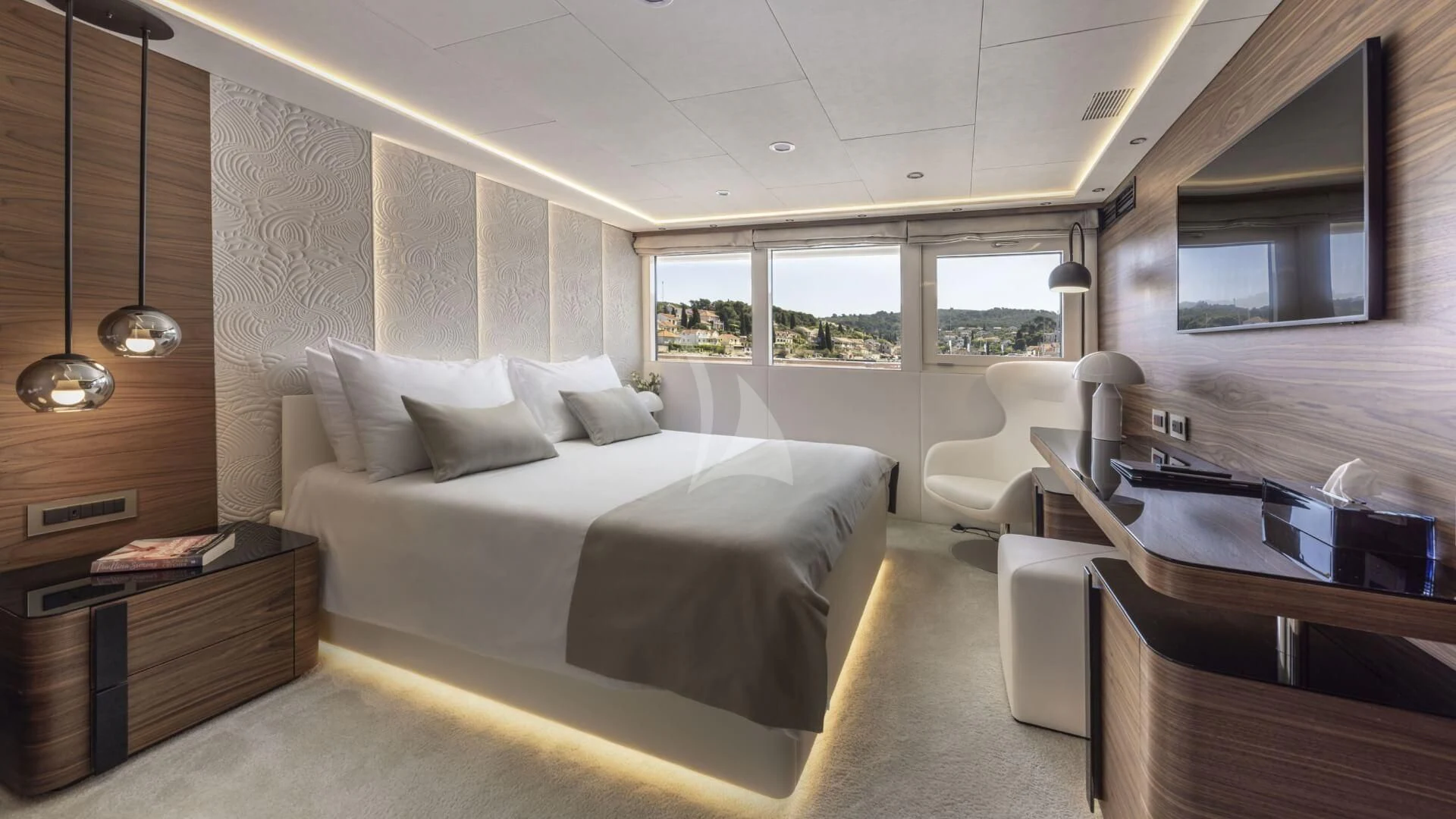 a bedroom with a bed and a desk aboard M/Y ANTHEA Yacht for Sale