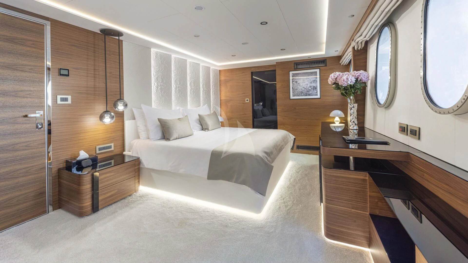 a room with a bed and a desk aboard M/Y ANTHEA Yacht for Sale