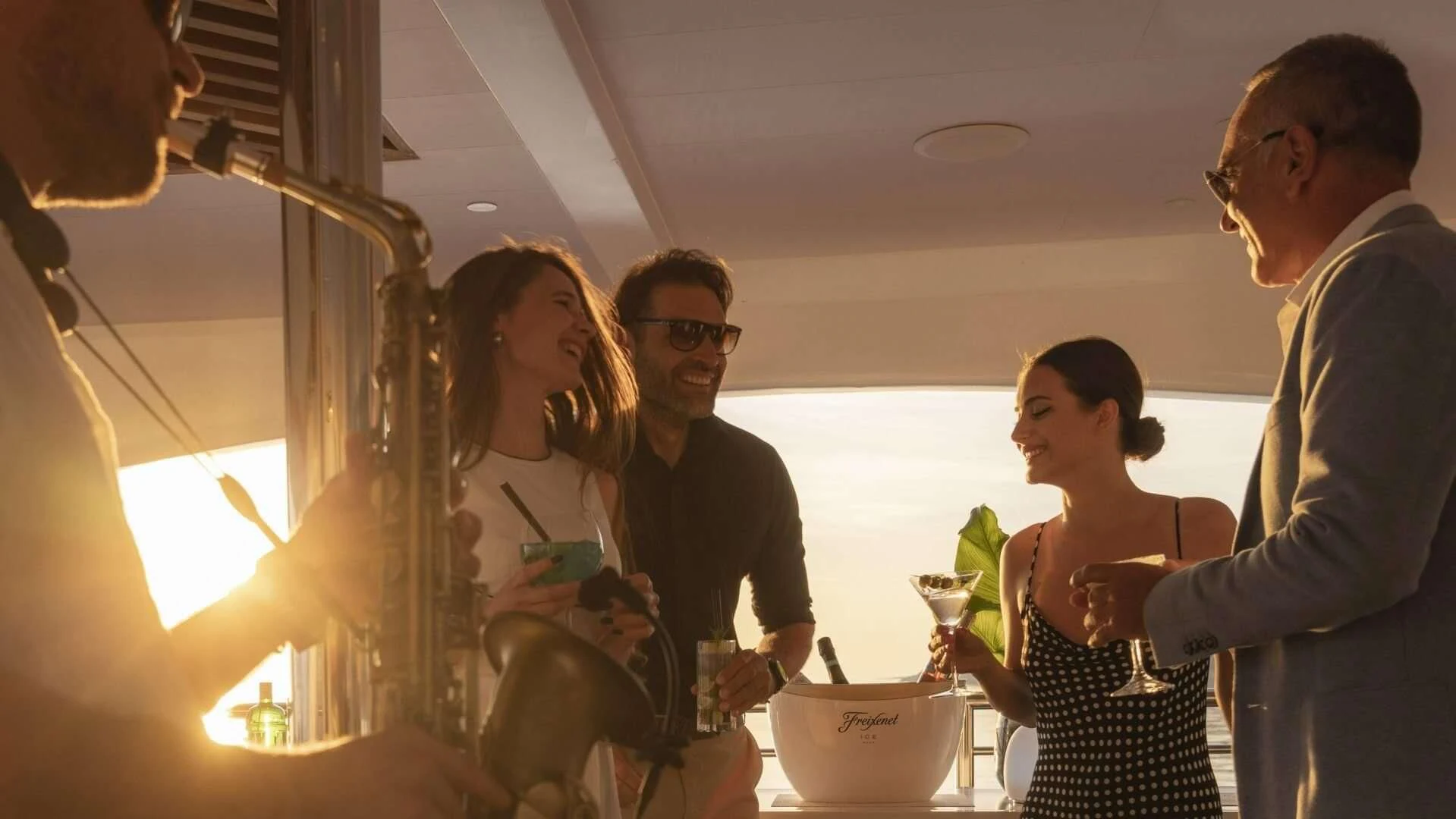 a group of people standing in a room with a table and a bowl aboard M/Y ANTHEA Yacht for Sale