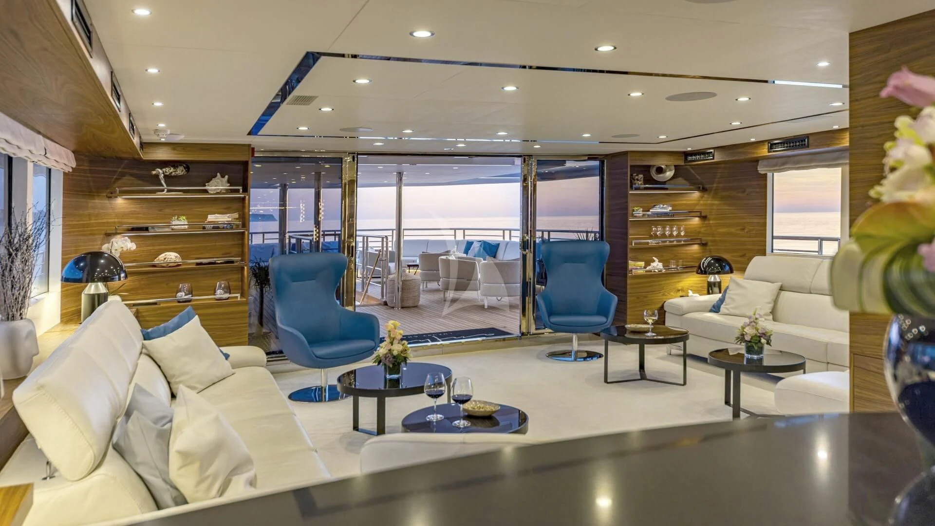 a living room with a large window aboard M/Y ANTHEA Yacht for Sale