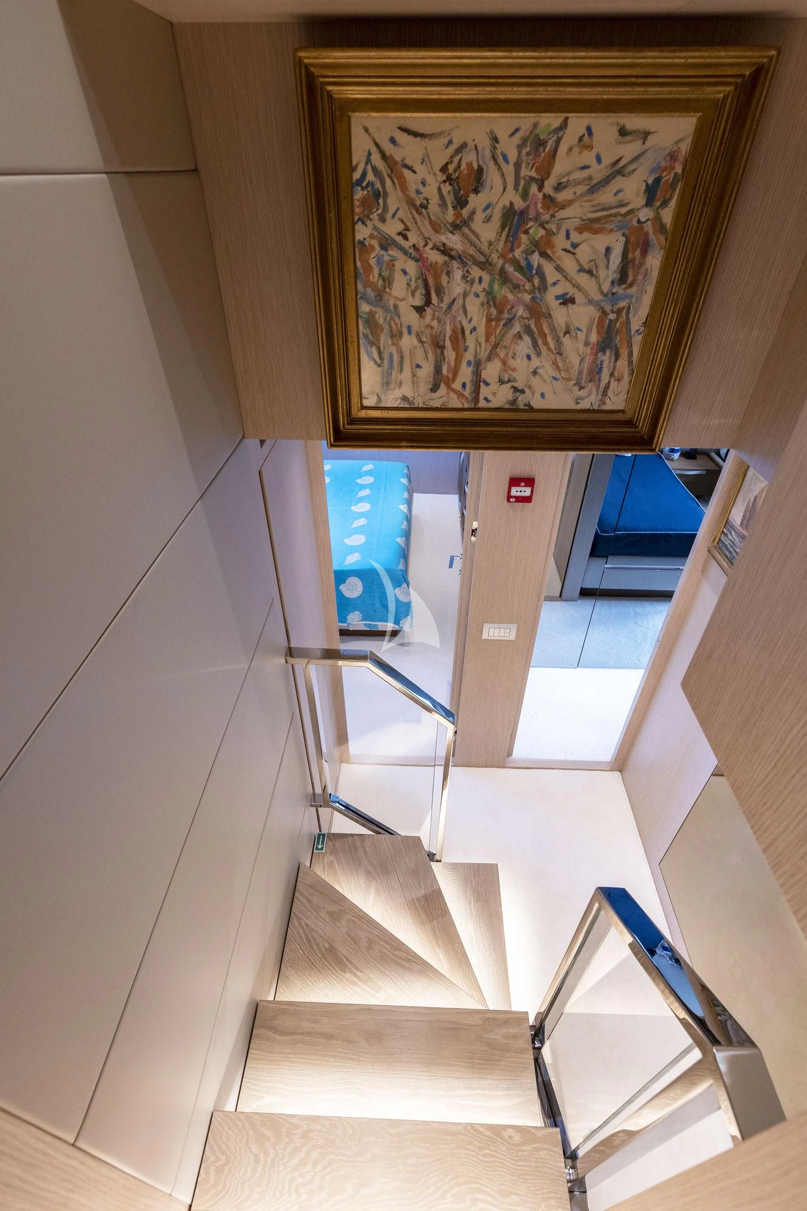 a staircase with paintings on the wall aboard VITTORIA Yacht for Charter