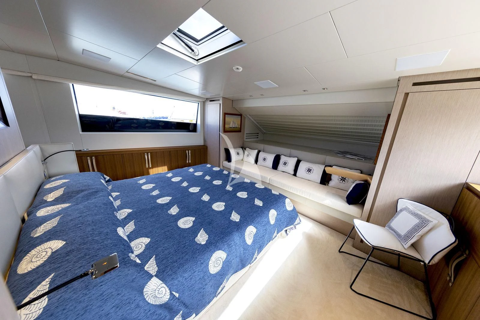 a room with a bed and a chair aboard VITTORIA Yacht for Charter