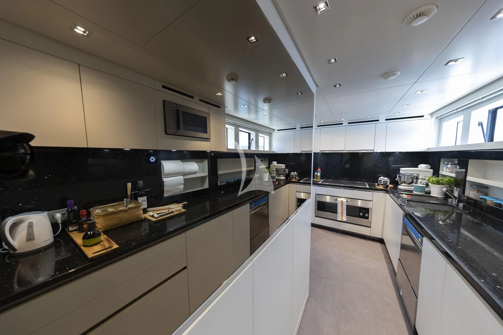 a kitchen with black counter tops aboard VITTORIA Yacht for Charter
