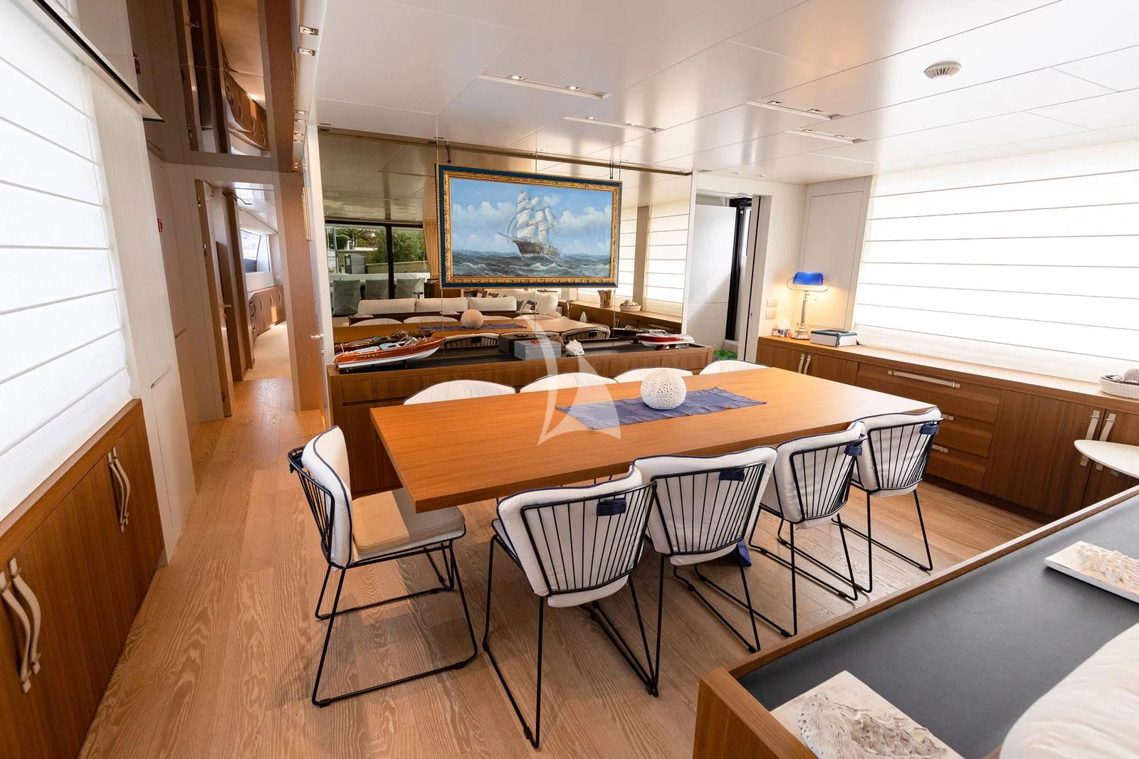 a large dining table in a living room aboard VITTORIA Yacht for Charter