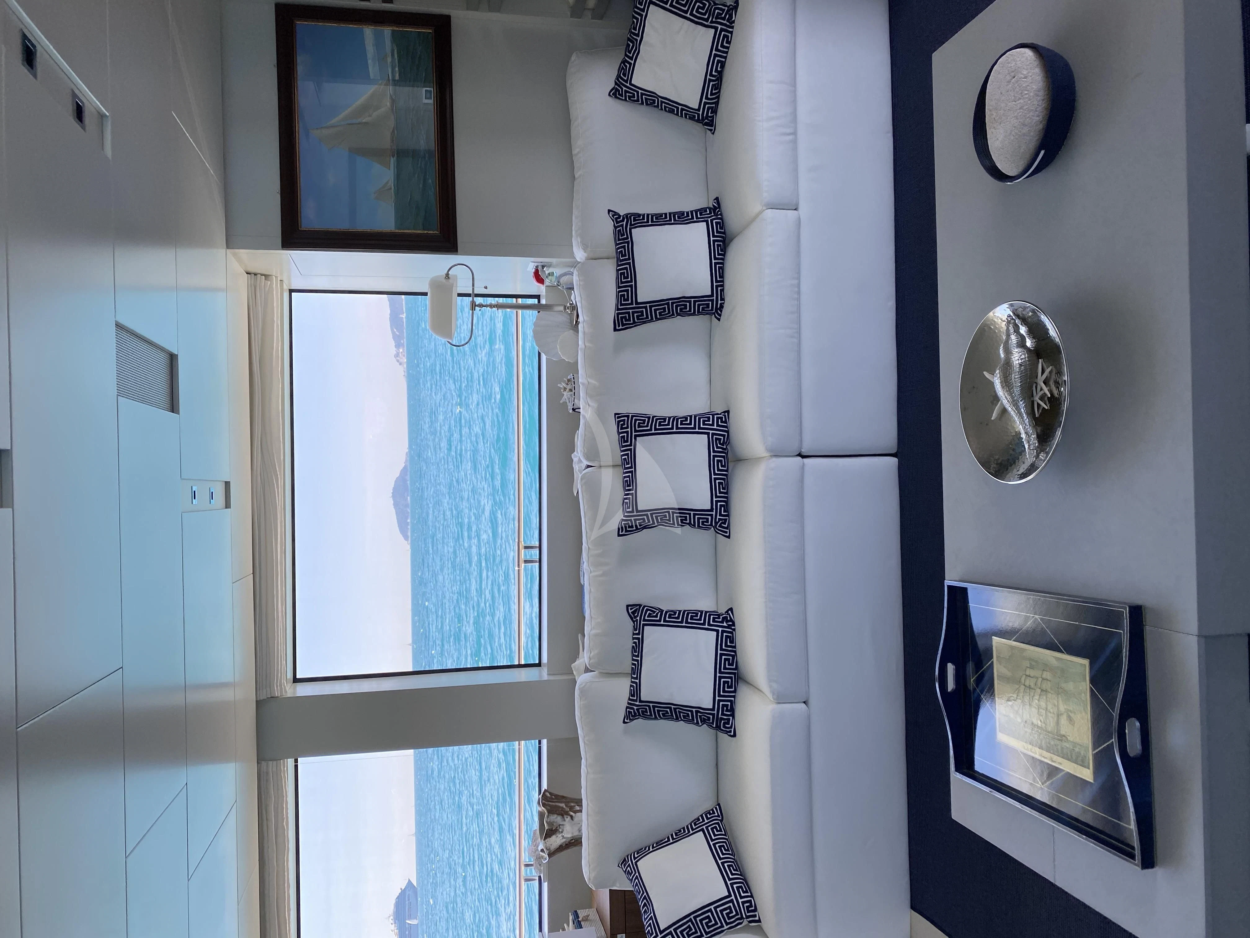 a room with a mirror and pictures on the wall aboard VITTORIA Yacht for Charter