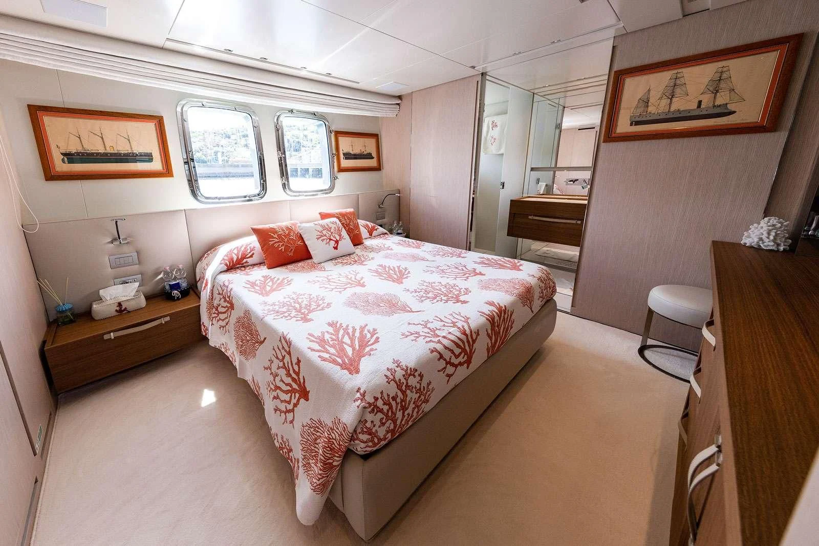 a bedroom with a bed and a desk aboard VITTORIA Yacht for Charter