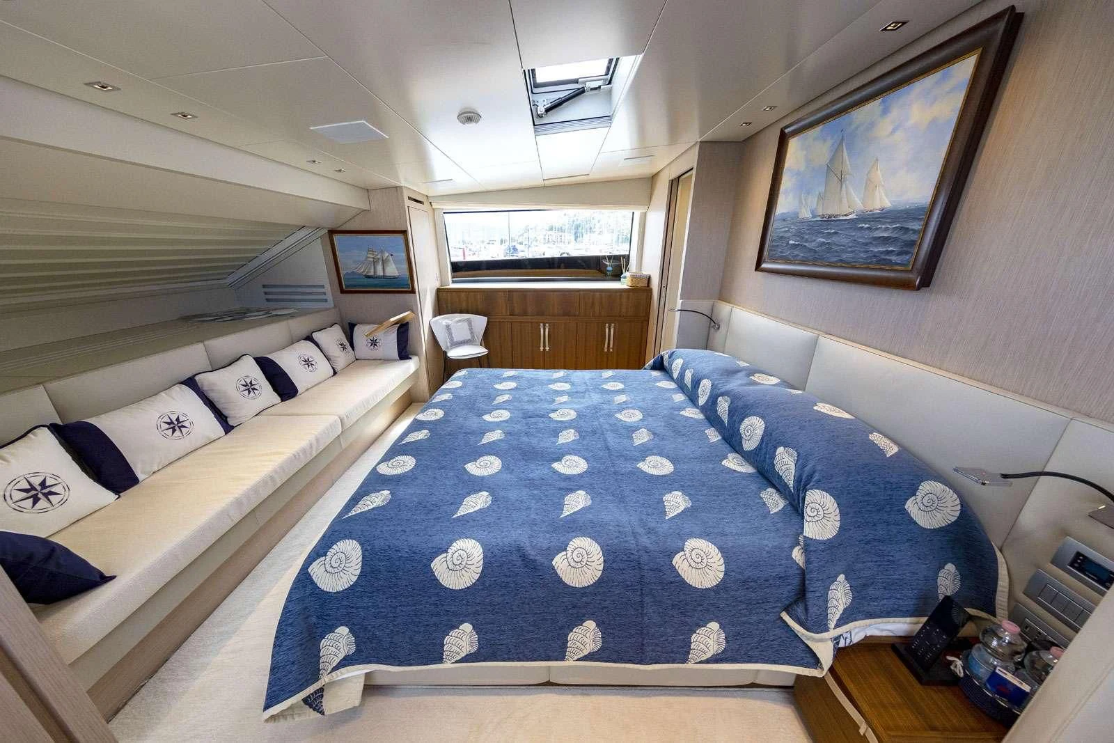 a room with a bed and a television aboard VITTORIA Yacht for Charter