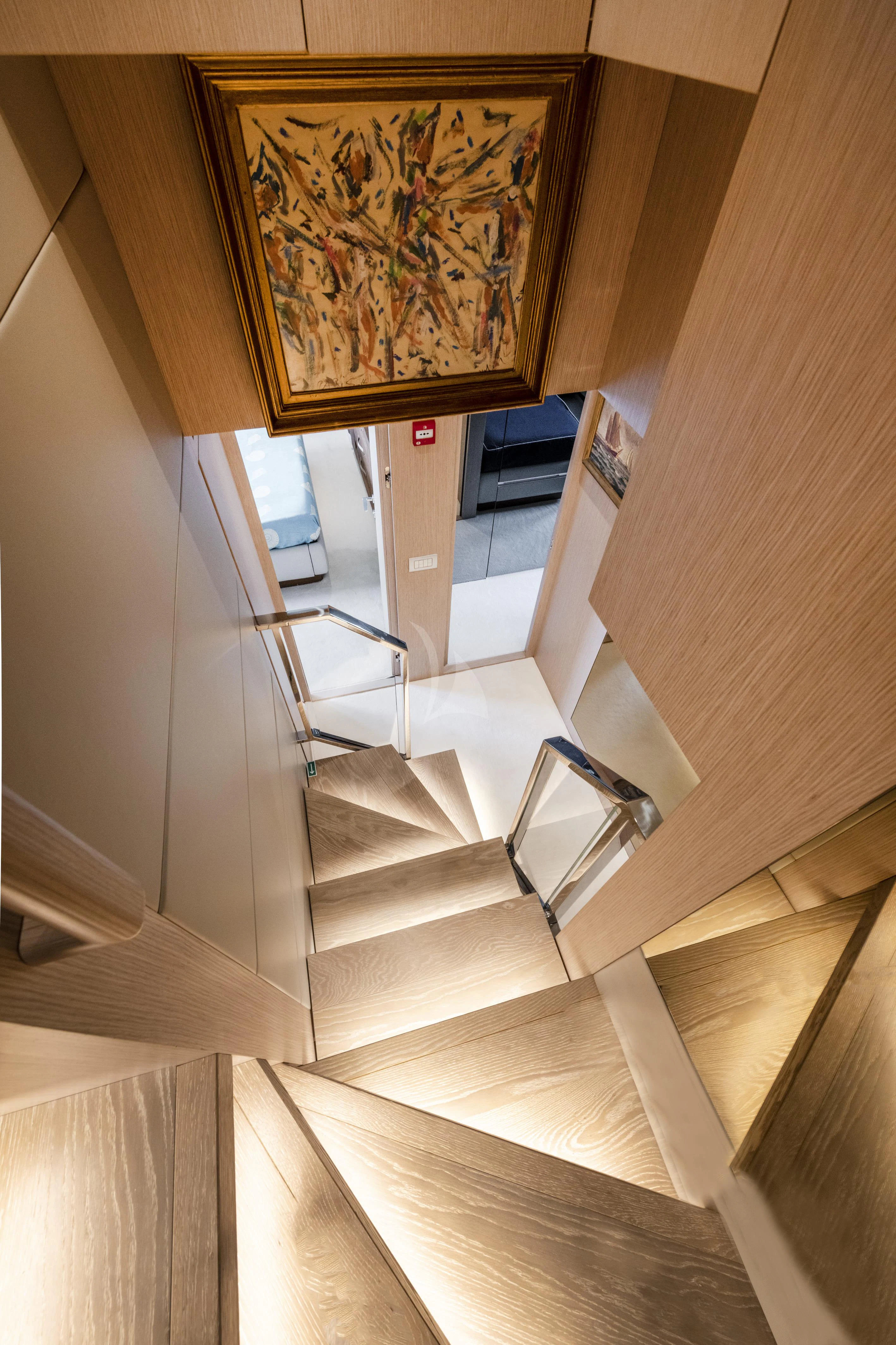 a staircase with a painting on the wall aboard VITTORIA Yacht for Charter