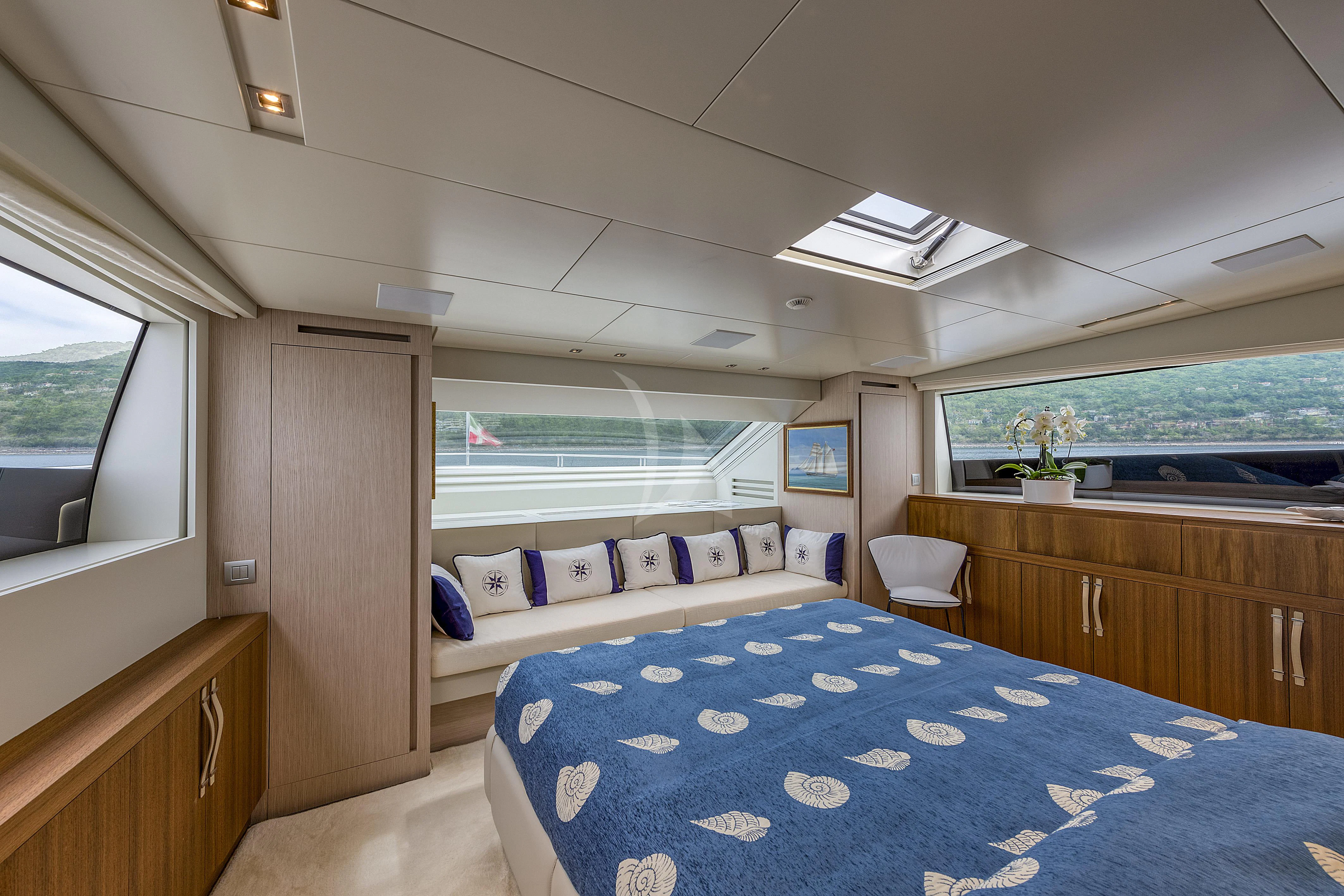 a bedroom with a blue bed aboard VITTORIA Yacht for Charter