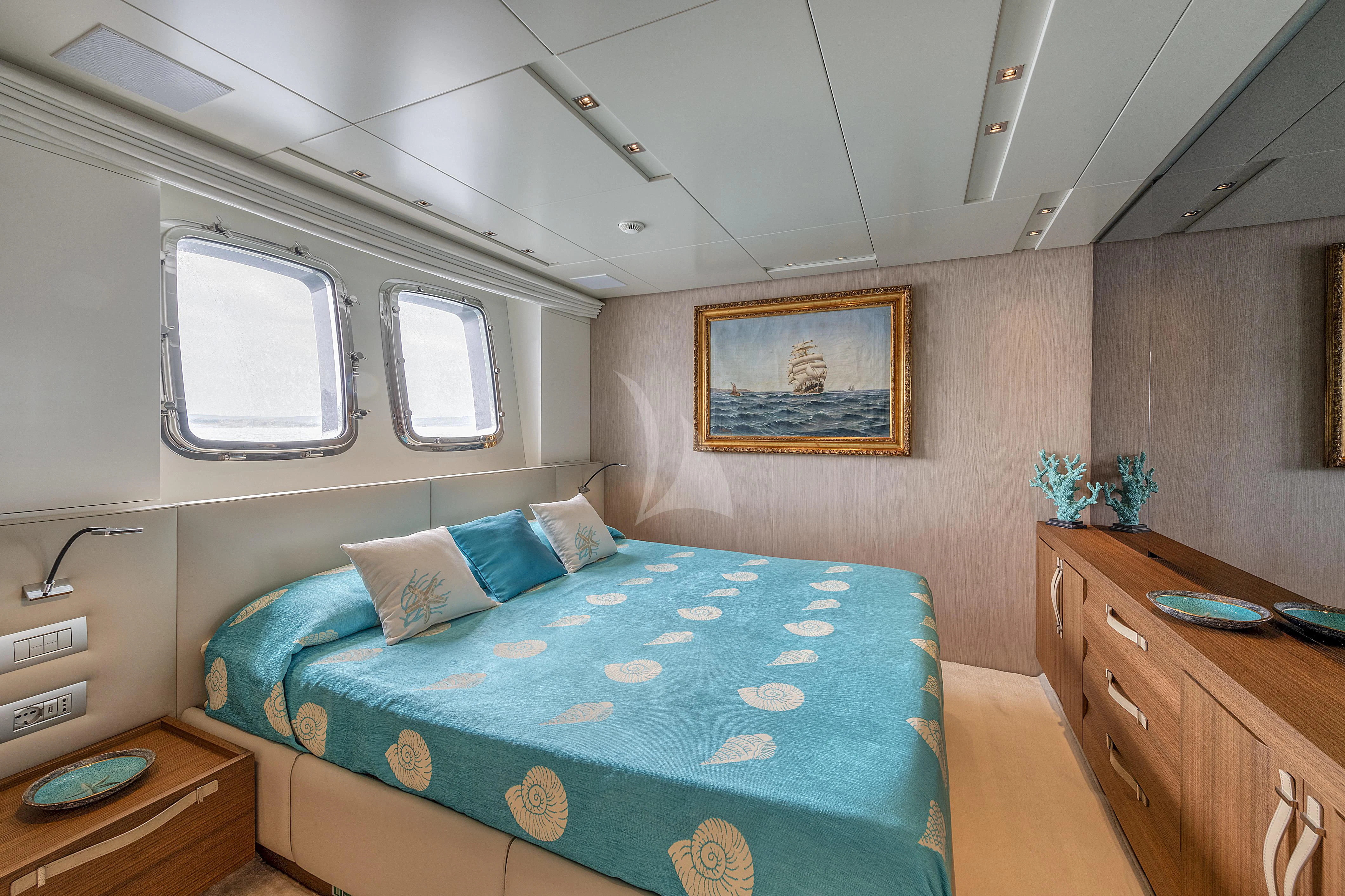 a bedroom with a bed and a desk aboard VITTORIA Yacht for Charter
