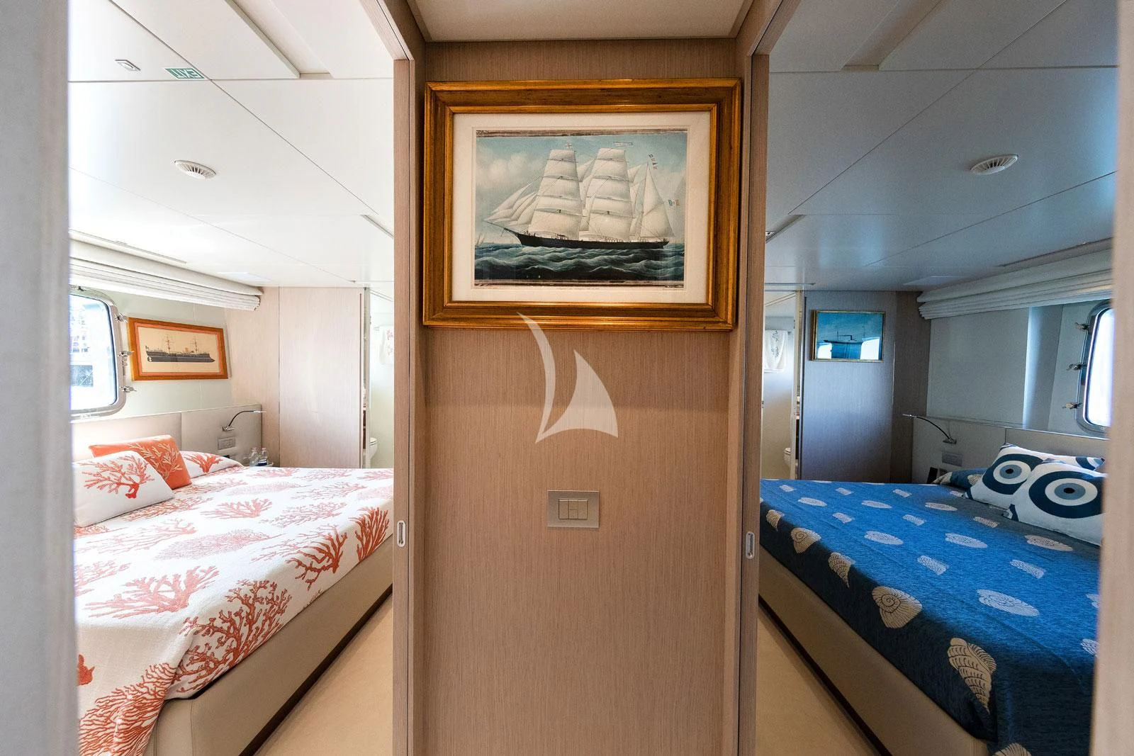 a room with beds and a television aboard VITTORIA Yacht for Charter