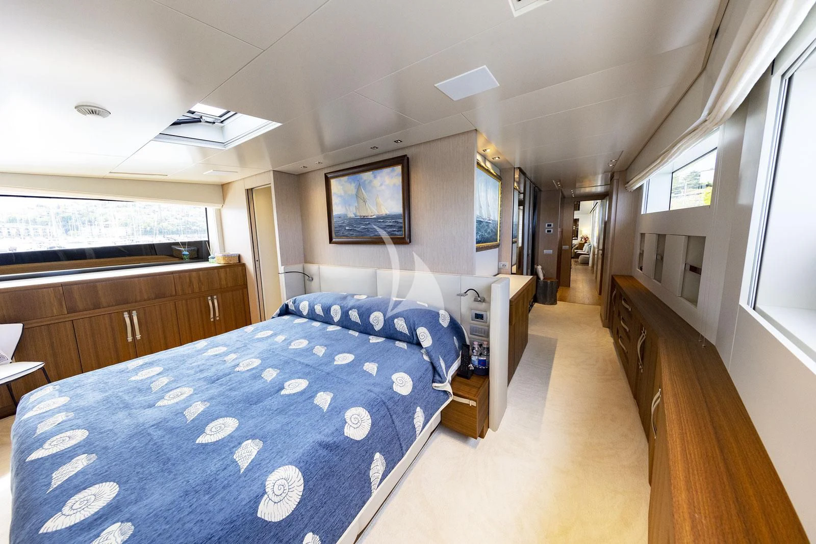 a bedroom with a bed and a tv on the wall aboard VITTORIA Yacht for Charter