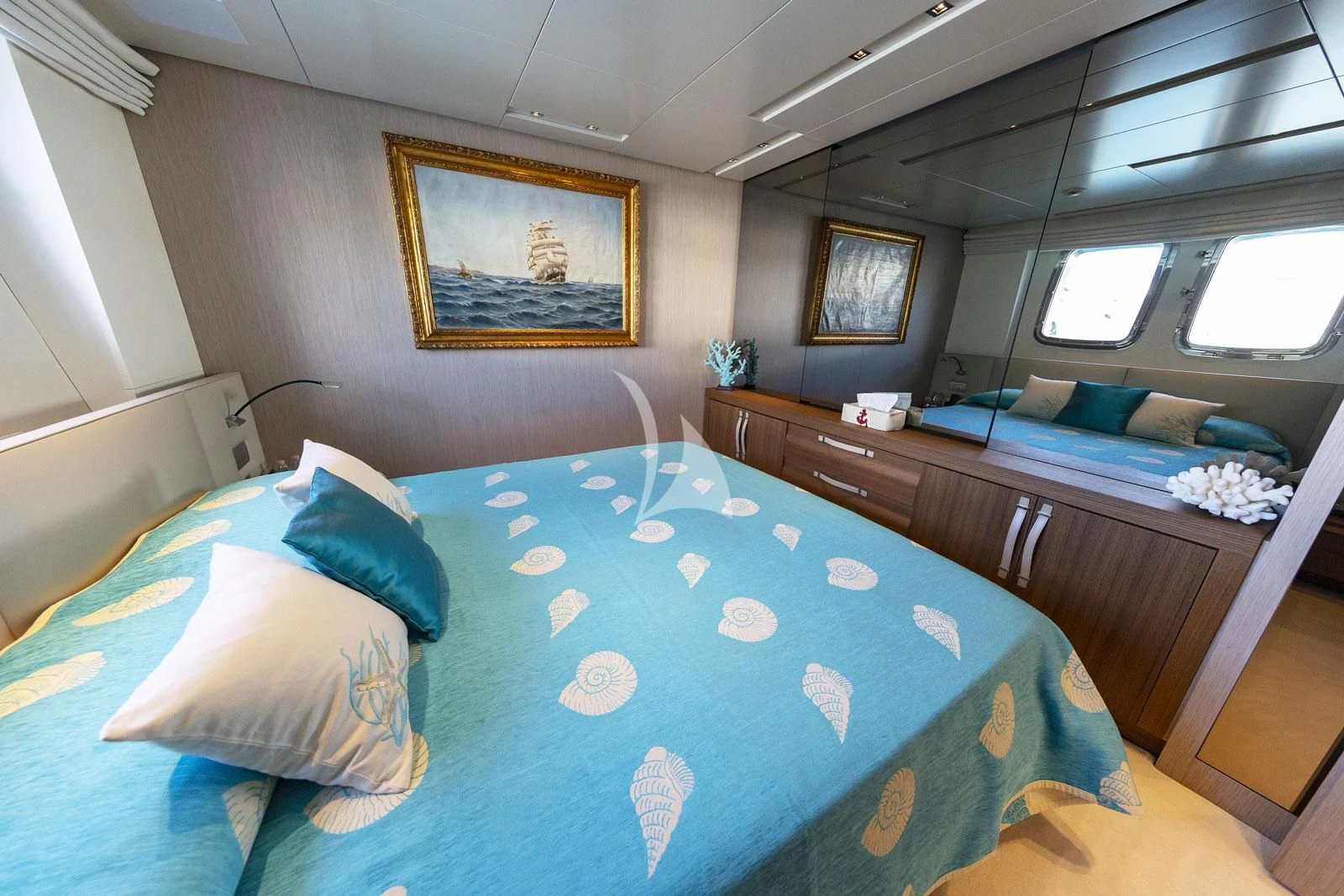 a room with a bed and a desk aboard VITTORIA Yacht for Charter
