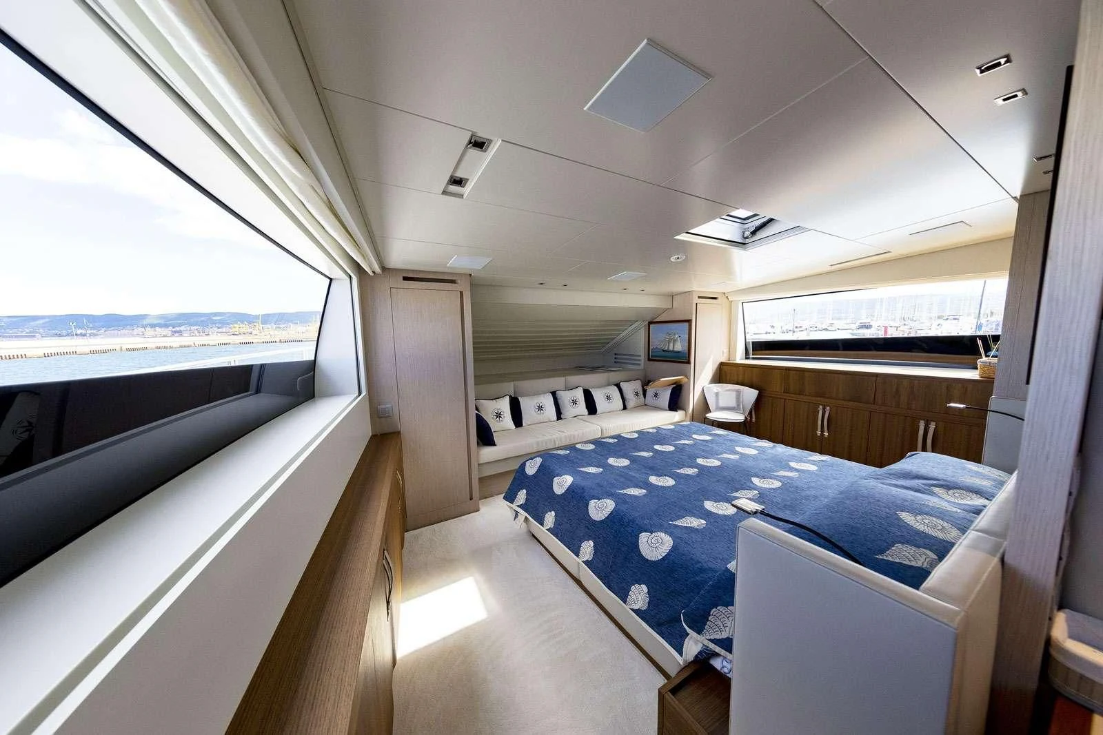 a room with beds and a window aboard VITTORIA Yacht for Charter