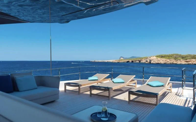a table and chairs on a deck aboard ACQUA Yacht for Sale