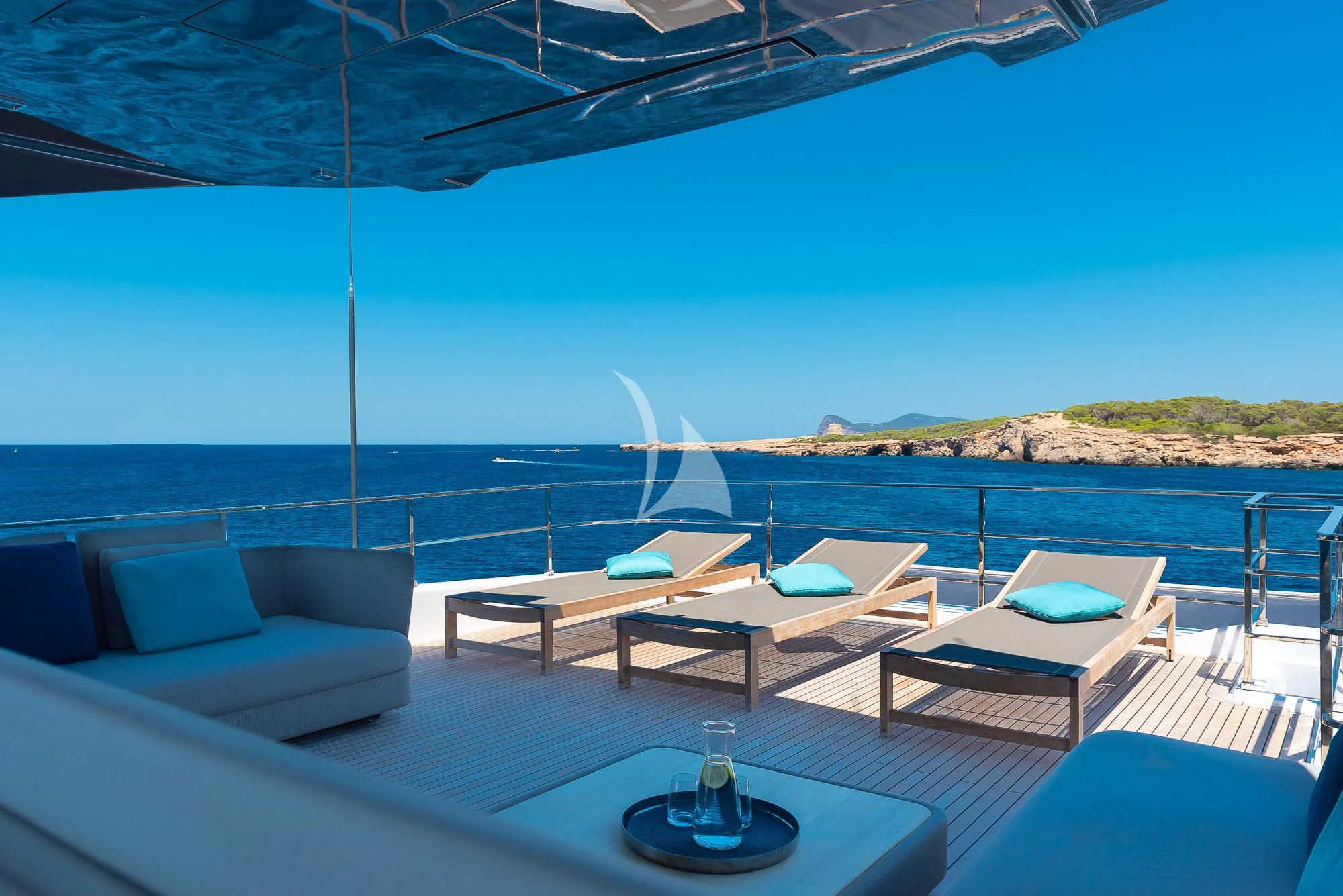 a patio with a table and chairs aboard ACQUA Yacht for Sale
