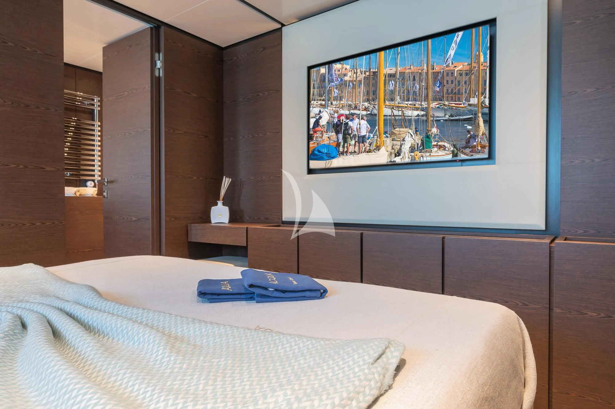 a bed with a picture on the wall aboard ACQUA Yacht for Sale