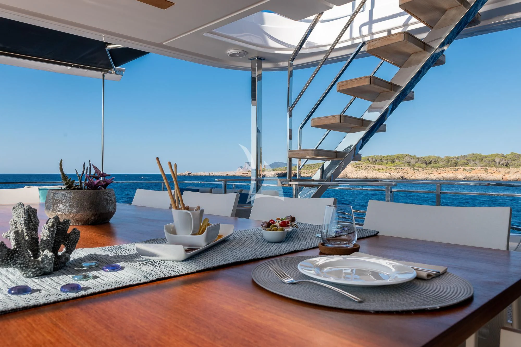 a table with plates and cups on it aboard ACQUA Yacht for Sale