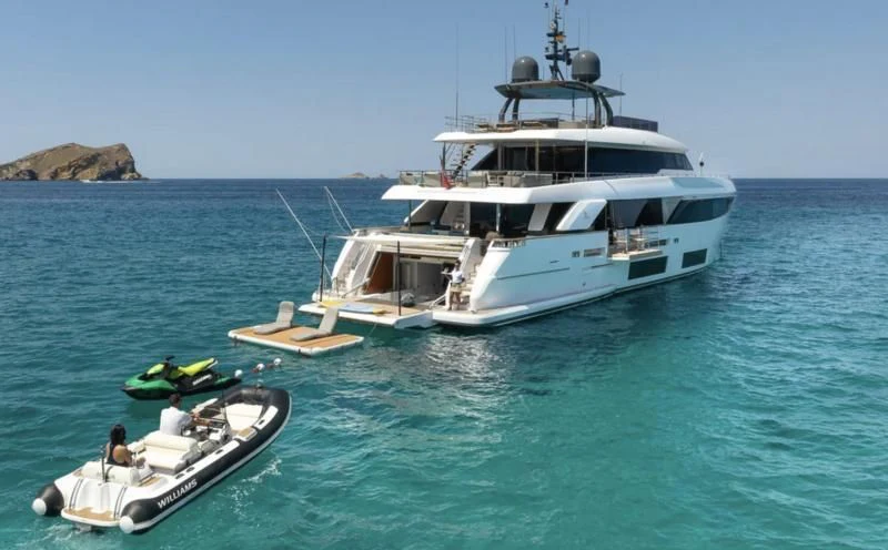 a boat and a motor boat in the water aboard ACQUA Yacht for Sale