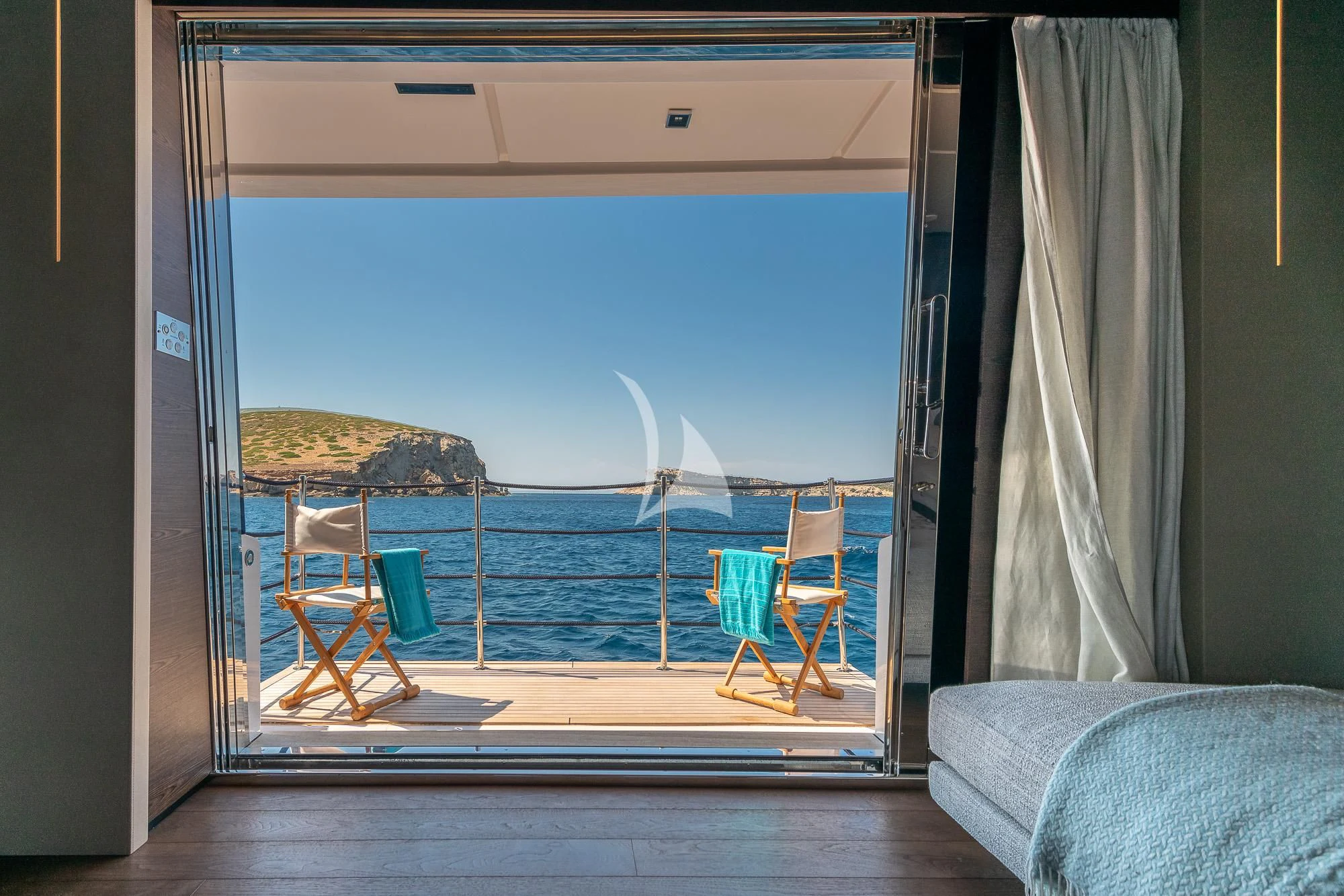 a window with a view of the ocean and beach aboard ACQUA Yacht for Sale