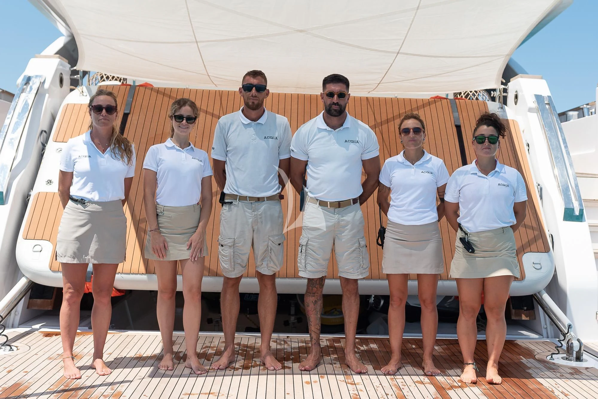 a group of people posing for a photo aboard ACQUA Yacht for Sale
