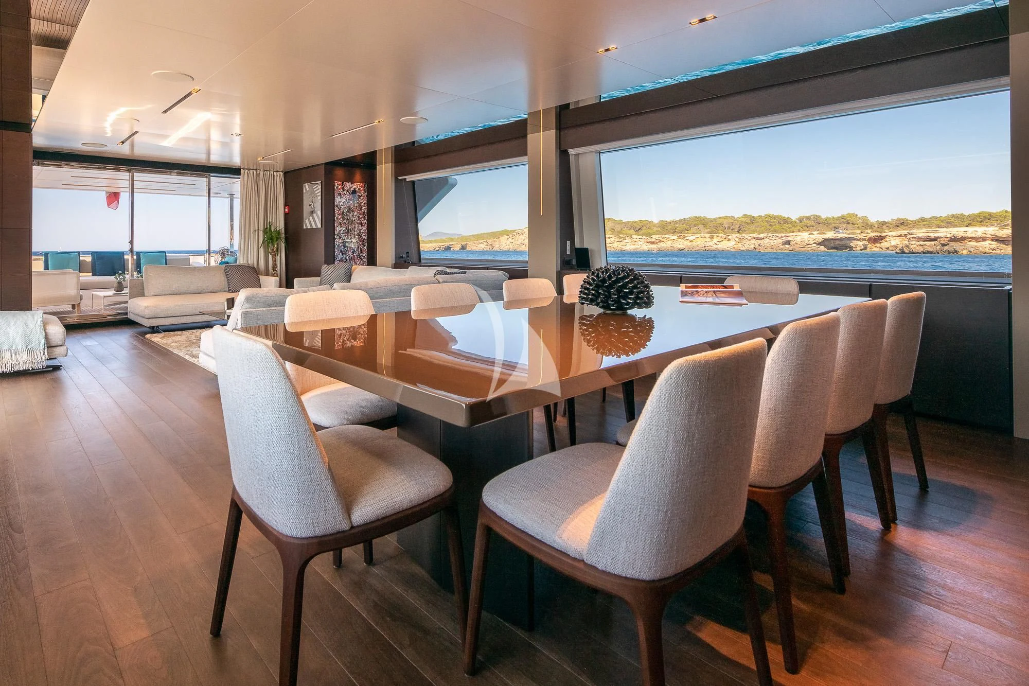 a dining room with a large window aboard ACQUA Yacht for Sale