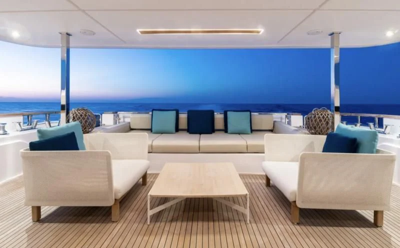 a room with a couch and a table and chairs aboard ACQUA Yacht for Sale
