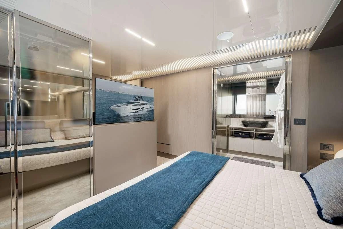 a bedroom with a bed and a large mirror aboard YEMAJA Yacht for Sale