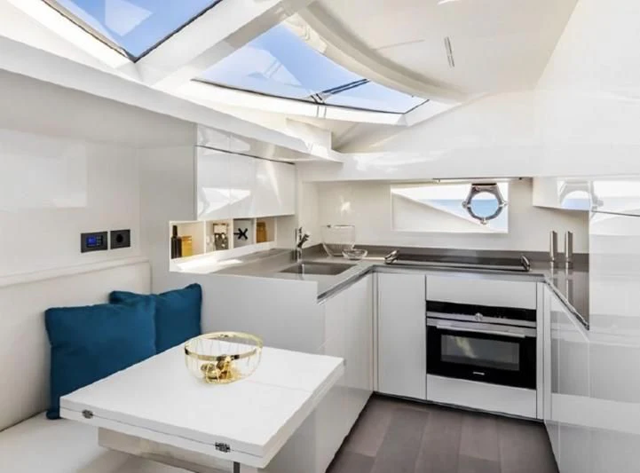 a kitchen with a white table and a white table aboard YEMAJA Yacht for Sale