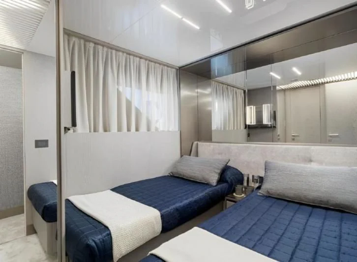 a room with a bed and a blue bed aboard YEMAJA Yacht for Sale
