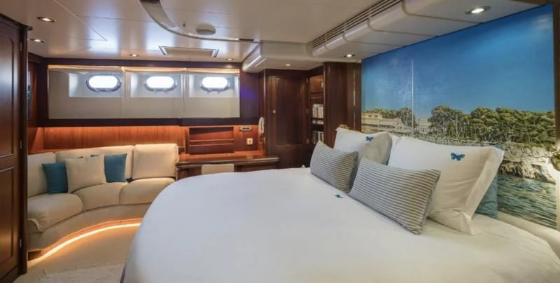 a room with a bed and a couch aboard BLUE PAPILLON Yacht for Sale