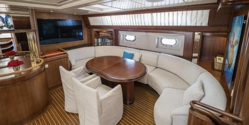 a living room with a table and chairs aboard BLUE PAPILLON Yacht for Sale