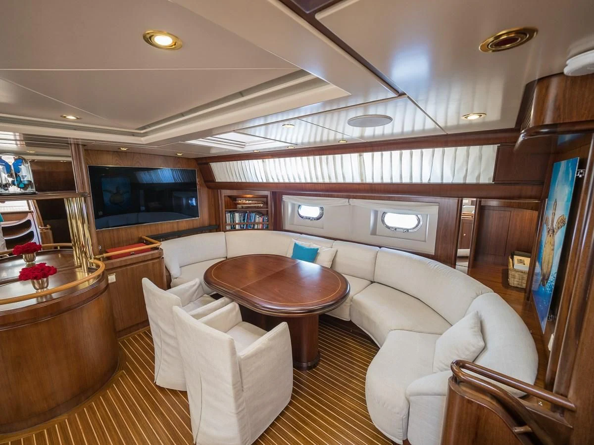 a living room with a large window aboard BLUE PAPILLON Yacht for Sale