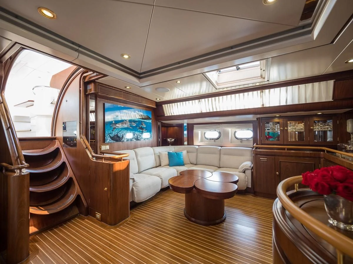 a living room with a large wood floor aboard BLUE PAPILLON Yacht for Sale