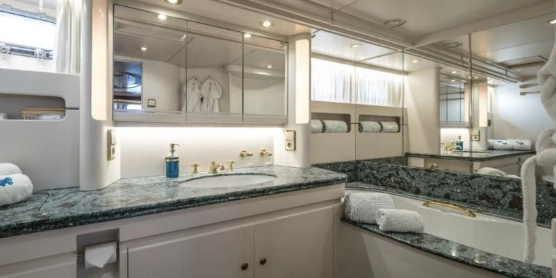 a large kitchen with white cabinets aboard BLUE PAPILLON Yacht for Sale