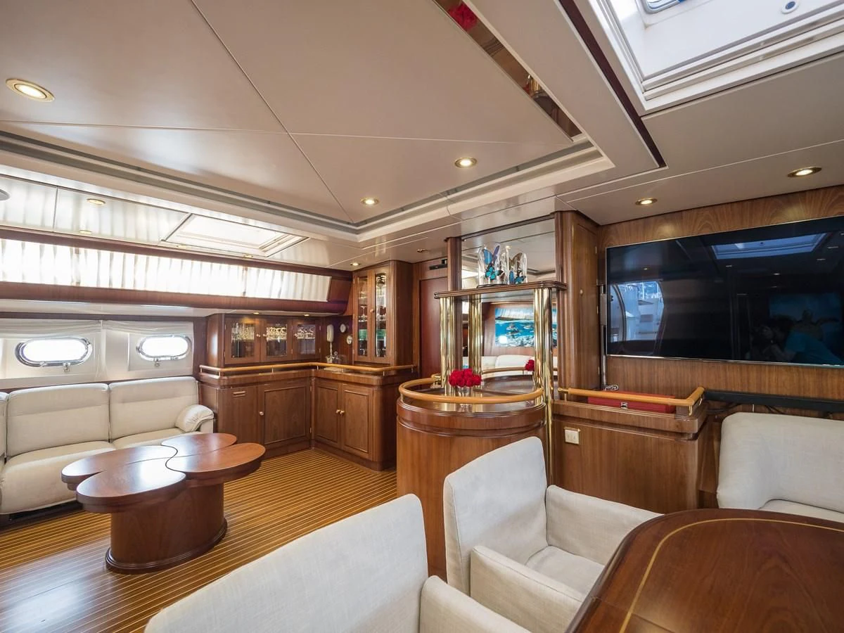 a living room with a table and chairs aboard BLUE PAPILLON Yacht for Sale