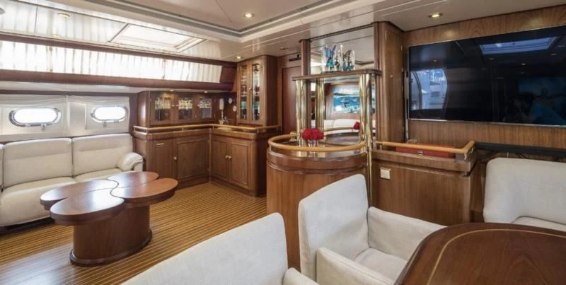 a living room with a table and chairs aboard BLUE PAPILLON Yacht for Sale