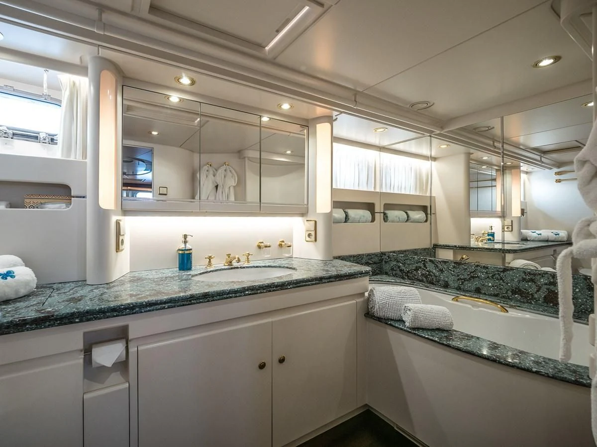 a large bathroom with marble counters aboard BLUE PAPILLON Yacht for Sale