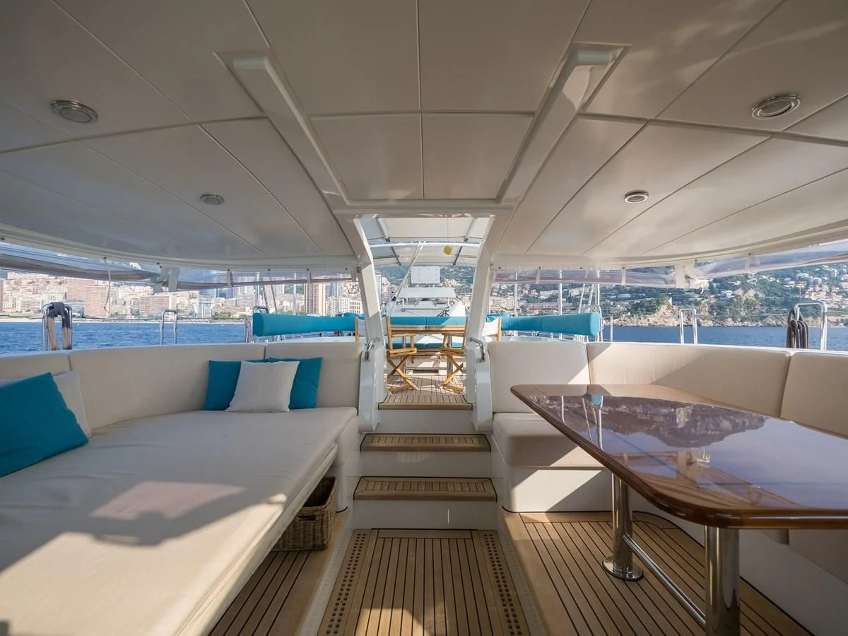 inside of a building with a view of the water and the deck aboard BLUE PAPILLON Yacht for Sale