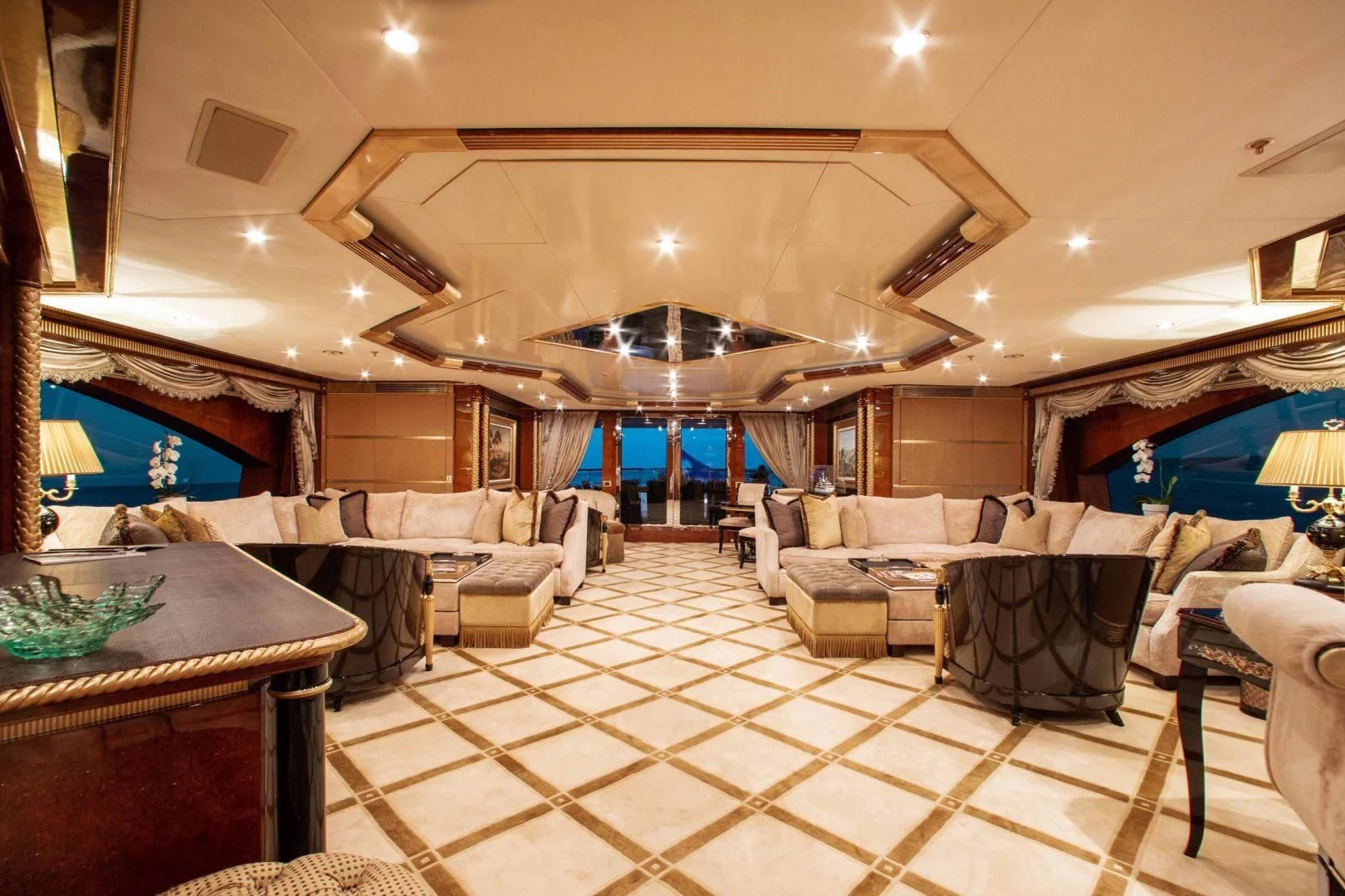 a large room with a table and couches aboard SORRENTO Yacht for Sale