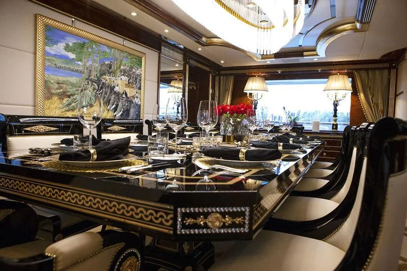 a large room with a table set for dinner aboard SORRENTO Yacht for Sale