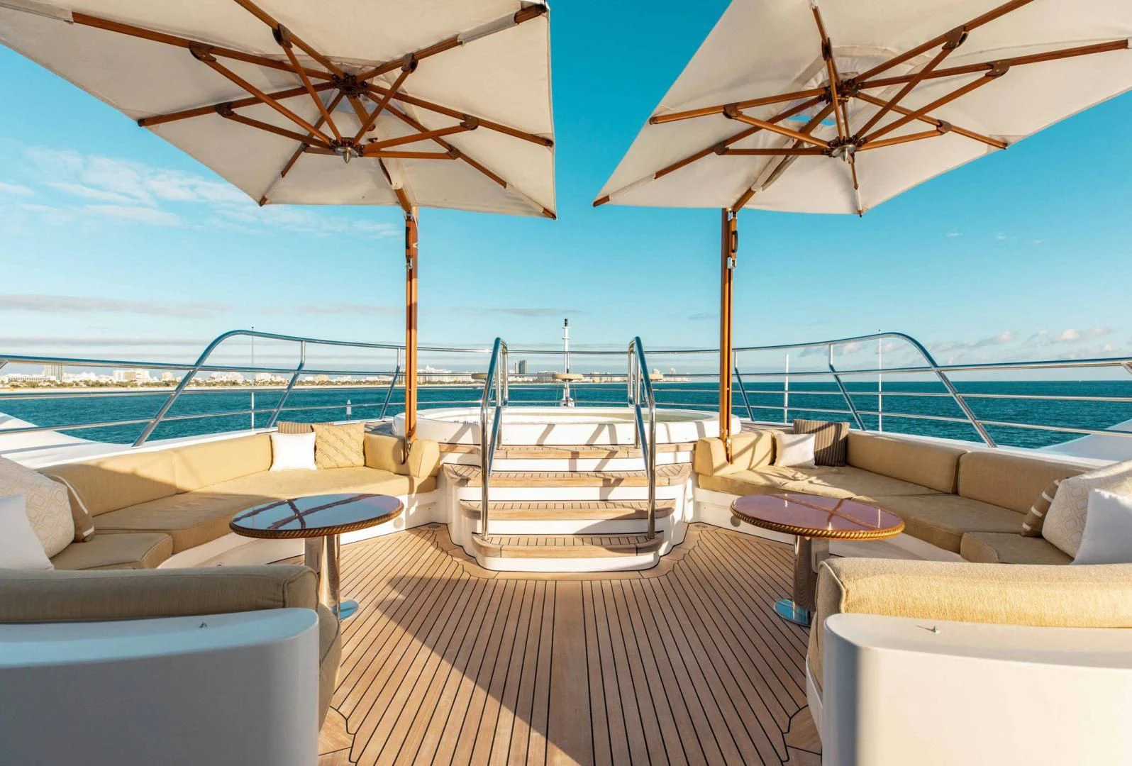 a lounge area with a deck and umbrellas aboard SORRENTO Yacht for Sale