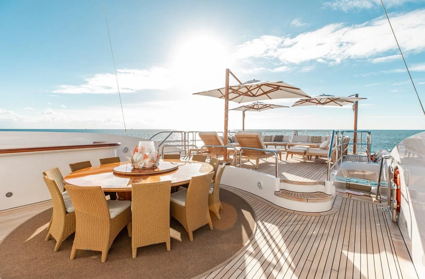 a deck with a table and chairs on it aboard SORRENTO Yacht for Sale