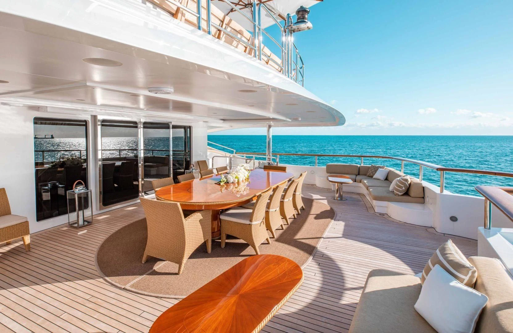 a table and chairs on a deck overlooking the ocean aboard SORRENTO Yacht for Sale